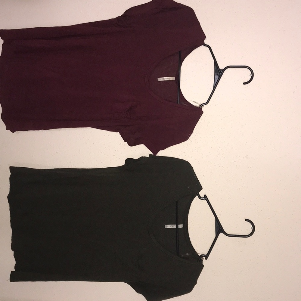 Two t-shirts . One burgundy and the other is green
